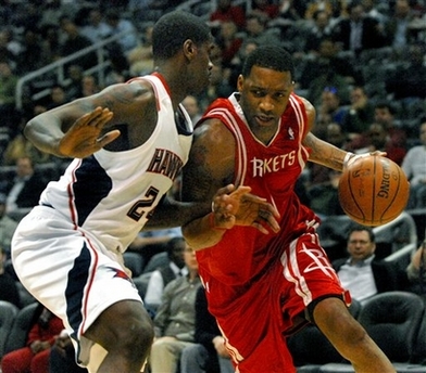 Houston Rockets guard Tracy McGrady, right, drives against Atlanta Hawks forward Marvin Williams, left, during the first quarter of an basketball game, Wednesday, March 12, 2008 at Philips Arena in Atlanta.