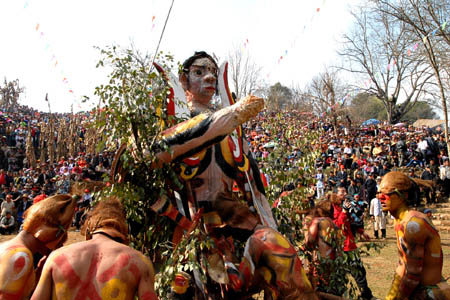 People carry the model of fire-lord during a fire-worshipping ceremony in Mi'le County, Southwest China's Yunnan Province, March 10, 2008. The local residents of Yi ethnic group of Mi'le County hold a mass annual festa on the 3rd day of the 2nd month in the Chinese Lunar calendar, which was an ancient fire-worshipping ceremony handed down from their ancestors. 