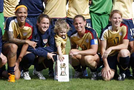 Soccer players of the US Catherine Whitehill (L), Haeter O'Reilly (2nd L), Christie Rampone (2nd R) with her daughter, and Lori Chalupny (R) pose with the World Algarve Cup women's soccer championship trophy after their match against Denmark at Vila Real Santo Antonio stadium March 12, 2008. 