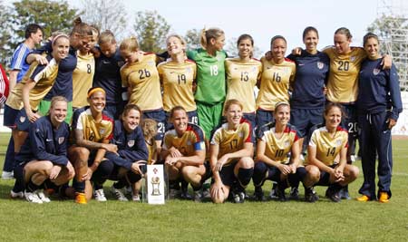 The US soccer team poses with the World Algarve Cup women's soccer championship trophy after winning against Denmark at Vila Real Santo Antonio stadium March 12, 2008. 