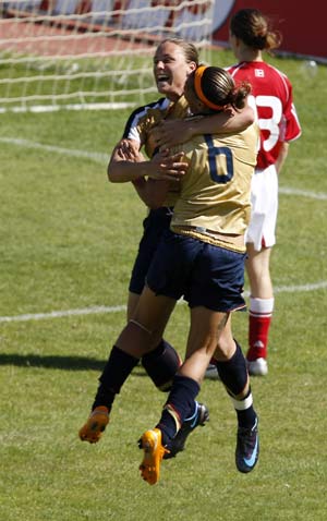 Abby Wambach (L) of US celebrates her goal with team mate Natasha Kai beside Denmark's Johanna Rasmussen during their World Algarve Cup women's soccer championship final at Vila Real Santo Antonio stadium March 12, 2008.