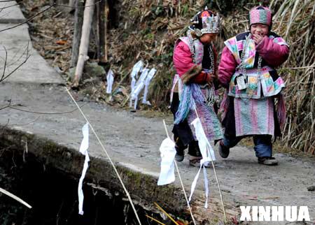 Ethnic Miao girls walk on a bridge after the celebration of Jingqiao festival (a feast dedicated to worship ancestors and bridges) in Jiuyang village of Jianhe County in Miao and Dong Autonomous Prefecture of southwest China's Guizhou province, on March 8, 2008. The traditional Miao ethinic festival, falling on the second day of the second month in the lunar calendar, is an occasion for festive indulgence and wish-making activities during the six-day celebration.