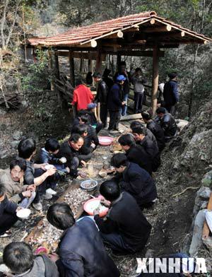 Local residents have their meal near the Fengyu Bridge during the celebration of Jingqiao festival (a feast dedicated to worship ancestors and bridges) in Jiuyang village of Jianhe County in Miao and Dong Autonomous Prefecture of southwest China's Guizhou province, on March 8, 2008. 