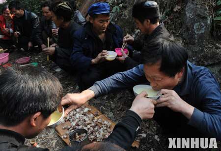 Local residents offer alcoholic drinks to each other during the celebration of Jingqiao festival (a feast dedicated to worship ancestors and bridges) in Jiuyang village of Jianhe County in Miao and Dong Autonomous Prefecture of southwest China's Guizhou province, on March 8, 2008.