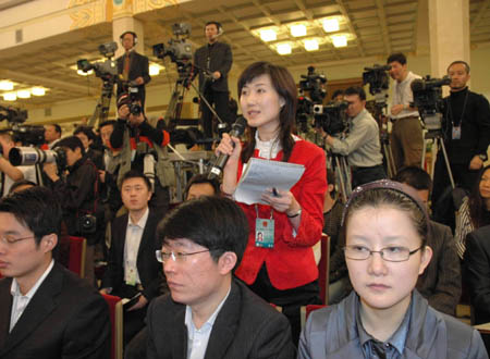 A journalist asks questions during Chinese Foreign Minister Yang Jiechi's meeting with the press at the Great Hall of the People in Beijing, capital of China, March 12, 2008. 