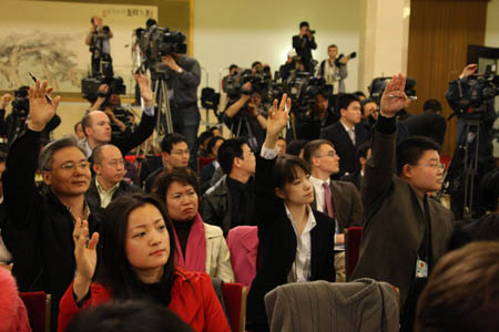Journalists raise hands for questions during Chinese Foreign Minister Yang Jiechi's meeting with the press at the Great Hall of the People in Beijing, capital of China, March 12, 2008.