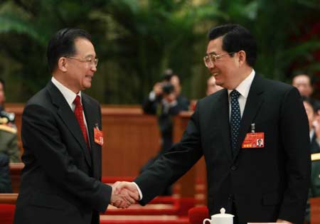 -- Chinese President Hu Jintao (R) shakes hands with Wen Jiabao after Wen was approved to be premier of China's State Council according to the result of a secret ballot by legislators during the sixth plenary meeting of the First Session of the 11th National People's Congress (NPC) in Beijing, capital of China, March 16, 2008. (Xinhua/Ju Peng)