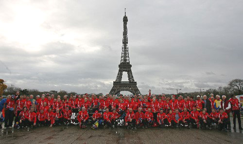 Riders take a group photo in front of the Eiffel Tower in Paris. The French Cycle Touring Federation organized a bicycle ride from Paris to Beijing, echoing the upcoming summer Olympics. Some 100 riders embarked on the cycling tour covering a distance of 12,000 kilometers on Sunday, and will arrive at the foot of Beijing's Great Wall on August 3. Two Chinese riders are taking part in this event.