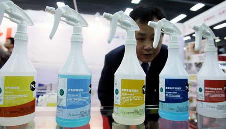 A visitor looks at environment-friendly cleansing products for hotels during the 14th China International Exhibition for Hotel & Restaurant Facilities, Equipment & Services, Food & Beverages that opened at the China World Trade Center Exhibition Hall in Beijing, capital of China, on March 16, 2008. 