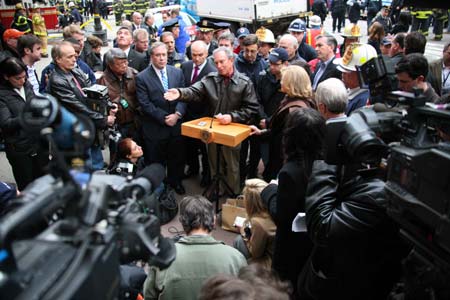 New York City Mayor Michael Bloomberg (C) speaks during a news conference near the site where a crane fell onto a building in New York March 15, 2008. 