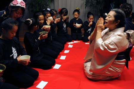 A Japanese tea ceremony artist performs the art of tea making in Nanjing, capital of east China's Jiangsu Province, on March 16, 2008. A Japanese delegation dedicated to a project of planting 5,000 cherry trees in a garden in Nanjing is now in China for a visit.