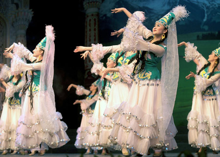 Perfomers dance during the party held in Xinjiang opera house to welcome the Noruz Festival in Urumqi, Xinjiang Uygur Autonomous Region, March 17, 2008. Noruz Festival, which falls on March 21 every year, means the day of spring rain. Muslim in China always celebrate the festival by dancing and performing acrobatics. (Xinhua/Zhao Ge)