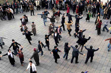 People dance on the square of Xinjiang opera house to welcome the Noruz Festival in Urumqi, Xinjiang Uygur Autonomous Region, March 17, 2008. (Xinhua Photo)