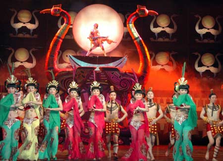 Dancers perform Chu Shui Ba Shan, an original drama displays a panorama of ancient people at the Three Gorges area of China, during a public show in Yichang City, central China's Hubei province, March 17, 2008. Chu Shui Ba Shan is created and performed by the Yichang Song and Dance Ensemble. The drama has been condensed and put into the tourism market as a culture product, into which bilingual host has been added, to meet the market needs. 