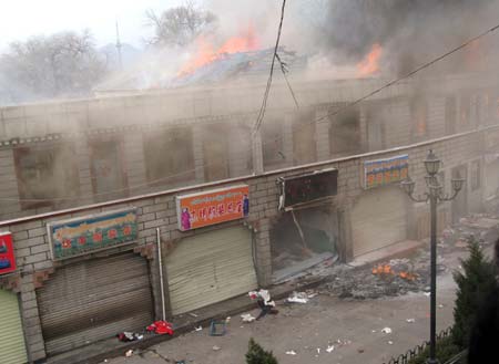 Stores near Ramogia Monastery are set on fire during the unrest in Lhasa, capital of southwest China's Tibet Autonomous Region, in this photo taken on March 14, 2008. (Xinhua Photo)