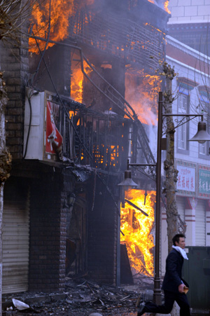 A store is set on fire during the unrest in Lhasa, capital of southwest China's Tibet Autonomous Region, in this photo taken on March 14, 2008. (Xinhua Photo)