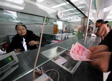 A staffer works at a bank branch in Lhasa, capital of southwest China's Tibet Autonomous Region, March 19, 2008. 