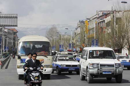  Vehicles run on a street in Lhasa, capital of southwest China's Tibet Autonomous Region, March 19, 2008. 