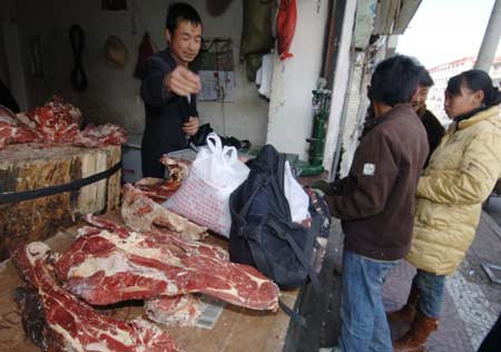 Local residents buy meat in Lhasa, capital of southwest China's Tibet Autonomous Region, March 19, 2008. 