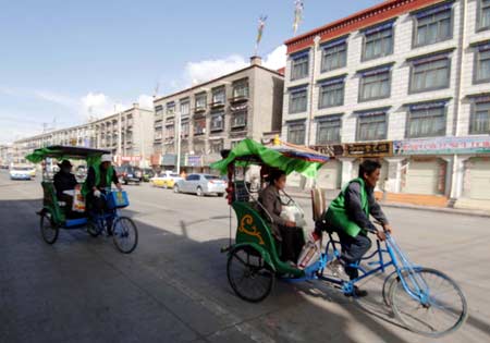 Pedicabs runs on a street in Lhasa, capital of southwest China's Tibet Autonomous Region, March 19, 2008. 