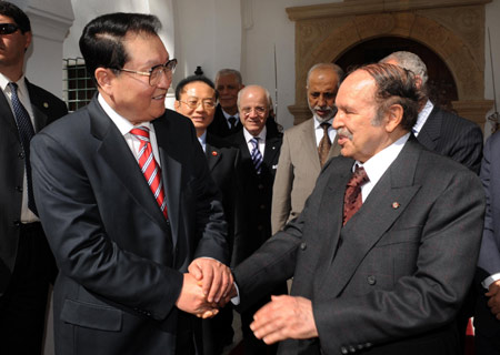 Li Changchun (L), member of the Standing Committee of the Political Bureau of the Communist Party of China (CPC) Central Committee, shakes hands with Algerian President Abdelaziz Bouteflika (R) in Algiers, Algeria, on March 24, 2008. Li said Monday that China is ready to boost cooperation with Algeria in the fields of energy resources, mining, and telecommunications. 
