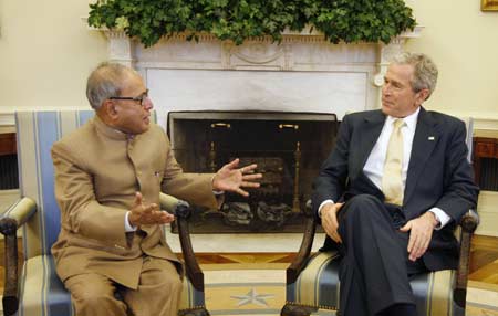 U.S. President George W. Bush (R) welcomes India's Foreign Minister Pranab Kumar Mukherjee to a meeting in the Oval Office at the White House March 24, 2008. 
