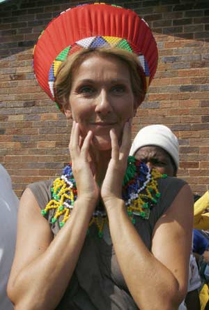 Canadian singer Celine Dion smiles as she poses in traditional Zulu beadwork and heargear at a school children feeding programme in Soweto township near Johannesburg, February 15 2008. 