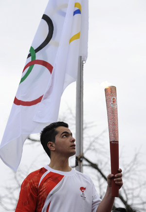 Torchbearer Yiogos from Ioanina of Greece holds the torch with the Olympic flame during the second day of the torch relay of the Beijing Olympic Games in Ioanina of Greece on March 25, 2008. 