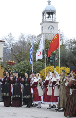 Local residents from Ioanina wait for the coming of the Olympic flame during the second day of the torch relay of the Beijing Olympic Games in Ioanina of Greece on March 25, 2008.