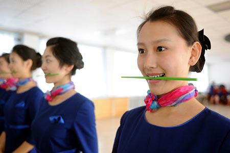 Girls practise smile during a training in Qingdao, east China's Shandong Province, March 25, 2008. 110 girls selected from 2000 applicants are trained to serve as stewards and ushers for the sailing competition at the 2008 Beijing Olympic Games. 