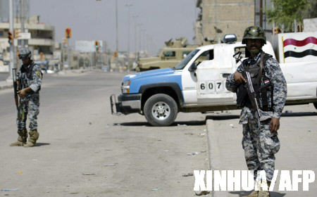 Policemen stand guard on a road in Basra March 25, 2008.