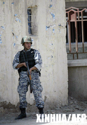 A policeman stands guard on a road in Basra March 25, 2008. 