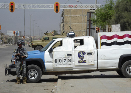 A policeman stands guard on a road in Basra March 25, 2008.