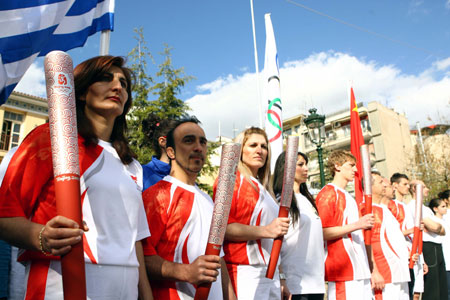 Torchbearers of the city of Kozani pose before taking part in the third-day torch relay of the Beijing Olympic Games, in Kozani of Greece on March 26, 2008. 