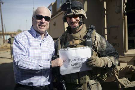 US Republican presidential candidate Senator John McCain (R-AZ) stands with Major Gordon Hilbun (R), McCain's vehicle commander in Haditha, Iraq, on March 16, 2008. Picture taken March 16, 2008. 