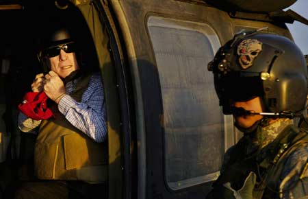  US Republican presidential candidate Senator John McCain (R-AZ) unbuckles his flight helmet as he arrives at Sather Air Base in Baghdad, March 16, 2008. Picture taken March 16, 2008. 