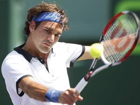 Switzerland's Roger Federer eyes the ball during his match against Sweden's Robin Soderling at the Sony Ericsson Open tennis tournament in Key Biscayne, Florida March 31, 2008.