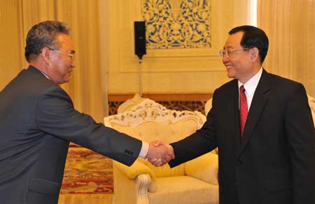 Wang Gang (R), a Political Bureau of the Communist Party of China Central Committee member and vice chairman of National Committee of the Chinese People's Political Consultative Conference, shakes hands with Paek Kye Ryong, head of the Democratic People's Republic of Korea delegation and secretary of the Workers' Party of Korea committee of the Ministry of Forestry, in Beijing, China, on April 1, 2008. 