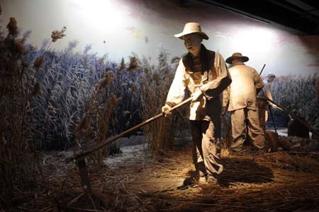 Photo taken on March 31, 2008, shows human sculpture "working" at the wetland museum in Tianjin, north China. As wetland covers less and less area in Tianjin, the museum was built and opened to arouse public awareness. 