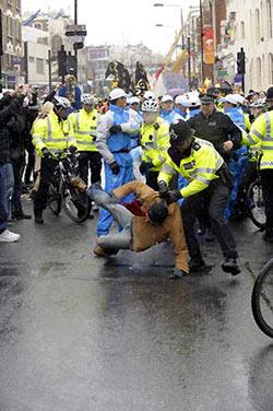 Local policeman clashes with a protester (bottom) during the Olympic torch relay in London, capital of Britain, April 6, 2008. A few 