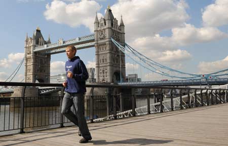 Mens elite marathon runner Ryan Hall of the U.S. poses for photographers in front of Tower Bridge in central London April 9, 2008. The annual London Marathon takes place on April 13.