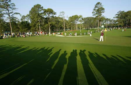 Long shadows are cast in the morning light as Aaron Baddeley of Australia walks across the 2nd green during a practice round for the 2008 Masters golf tournament at the Augusta National Golf Club in Augusta, Georgia, April 9, 2008.
