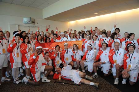 Some torchbearers pose for a group photo at a closing ceremony held at the airport in San Francisco, the United States, April 9, 2008. San Francisco is the sixth stop of the 2008 Beijing Olympic Games torch relay outside the Chinese mainland.