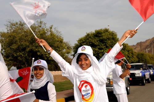 Photo: A girl waving the flages hails for the arrival of the sacred flame