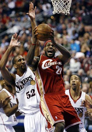 Cleveland Cavaliers forward LeBron James (23) shoots under pressure from the Philadelphia 76ers center Calvin Booth (52) during second quarter NBA basketball action in Philadelphia, Pennsylvania, April 14, 2008. 