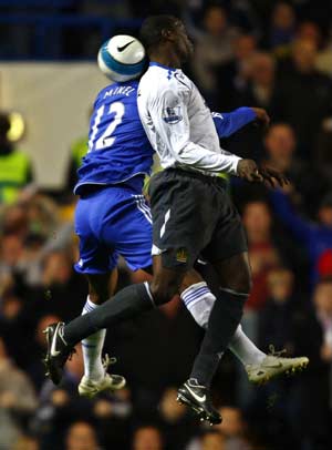 Chelsea's John Obi Mikel (L) challenges Wigan Athletic's Emile Heskey during their English Premier League soccer match at Stamford Bridge in London April 14, 2008. 