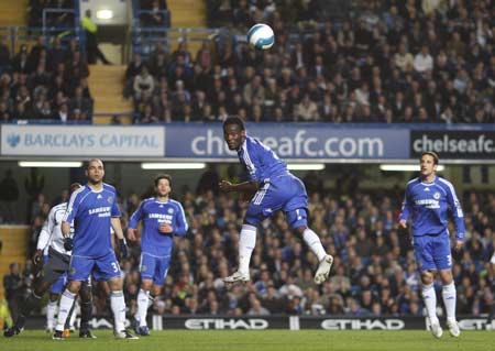 Chelsea's Michael Essien heads the ball away from Wigan Athletic during their English Premier League soccer match at Stamford Bridge in London April 14, 2008. 