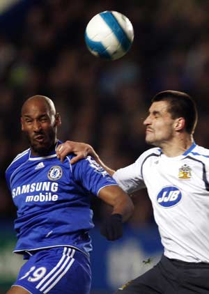 Chelsea's Nicolas Anelka (L) challenges Wigan Athletic's Paul Scharner during their English Premier League soccer match at Stamford Bridge in London April 14, 2008. 