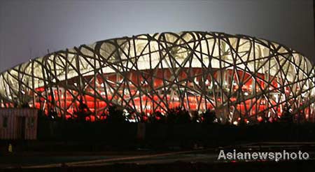 The National Stadium of China, also known as the Bird's Nest and the main venue holding the opening ceremony of the 2008 Olympics, conducts lighting tests in Beijing, April 13, 2008.