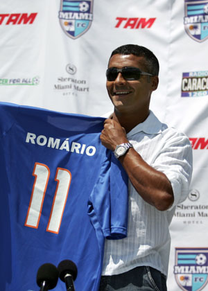 Brazilian soccer star Romario holds up his shirt for the media after joining the Miami Football Club in the United Soccer League in Miami, Florida April 7, 2006. Romario announced his retirement on Monday after collecting over 1,000 scores in his career.
